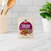 A packet of McCormick Teriyaki Chicken seasoning mix is displayed on a kitchen counter.