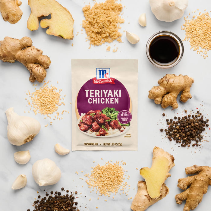 A McCormick Teriyaki Chicken seasoning packet is surrounded by fresh ingredients like ginger, garlic, and peppercorns.