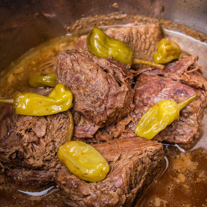 A close-up of Mississippi pot roast with pepperoncini peppers, showcasing a hearty and flavorful meal.