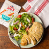 ['McCormick Just 5 Homestyle Ranch seasoning mix with a plate of chicken and salad.']