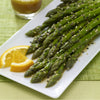['A plate of asparagus spears with sesame seeds and black sesame seeds.']