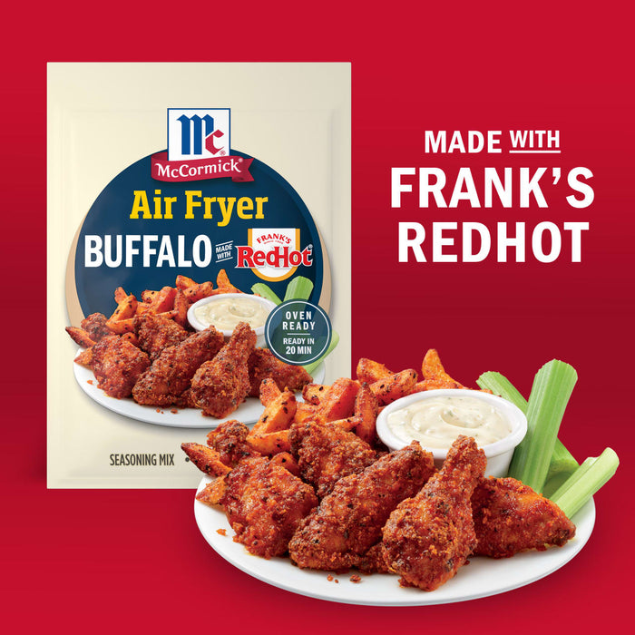 McCormick Air Fryer Buffalo seasoning mix made with Frank's RedHot is shown with a plate of buffalo wings, sweet potato fries, celery sticks, and dipping sauce.