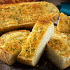 ['A close up of several slices of toasted garlic bread.']