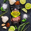 A package of McCormick Grill Mates Brazilian Steakhouse marinade is surrounded by fresh ingredients like garlic lime and herbs.
