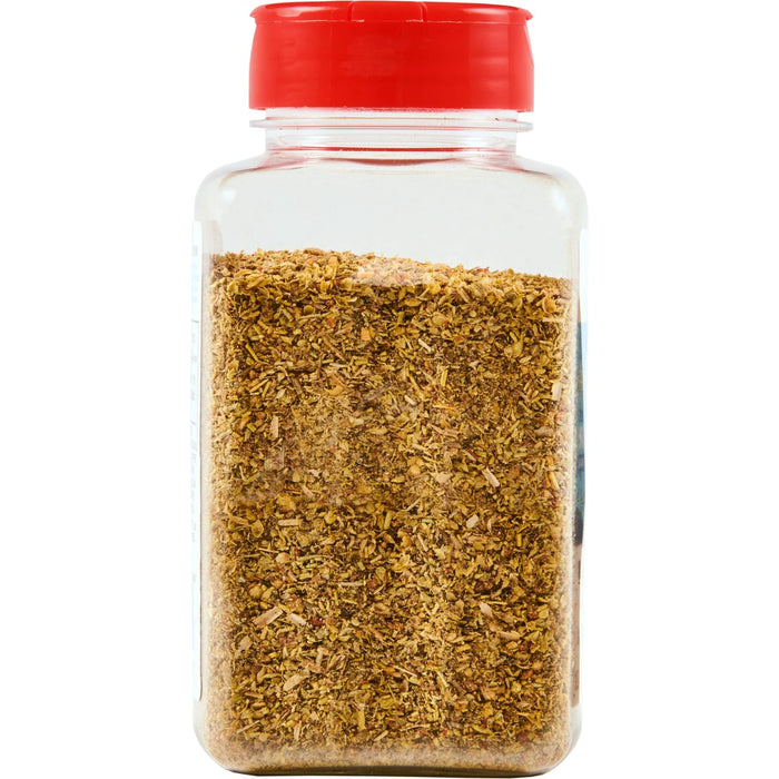 ['A glass jar with a red lid filled with dried herbs.']