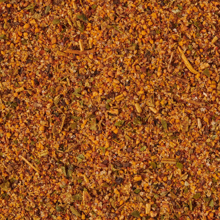 A close-up of a blend of spices including salt herbs and other seasonings.
