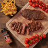 McCormick Grill Mates Chili Garlic Tri-Tip seasoning with grilled steak fries and cherry tomatoes.
