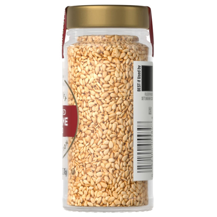 A glass jar of McCormick Sesame Seeds with a green lid.