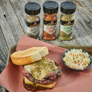 ['McCormick Grill Mates seasoning jars with a roast beef sandwich and coleslaw.']