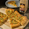 ['A close-up of a pizza with a McCormick Grill Mates seasoning jar.']