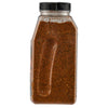 ['A clear plastic bottle filled with a brown spice blend.']