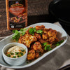 ['A plate of roasted cauliflower florets seasoned with McCormick Grill Mates Fiery Habanero &amp; Roasted Garlic seasoning and served with a side of dipping sauce.']