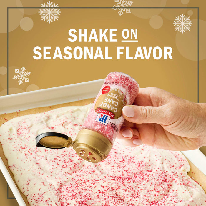 A hand sprinkles McCormick's seasonal flavor sprinkles onto a frosted dessert.