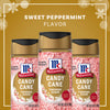 A jar of McCormick Candy Cane Seasoning is surrounded by candy canes, highlighting its sweet peppermint flavor.