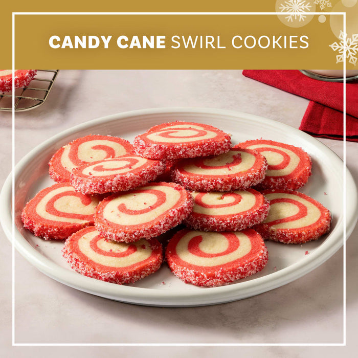A rolled cookie dough covered in pink sprinkles is being prepared for holiday bark and cookies.