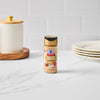A bottle of McCormick Grill Mates Montreal Steak Seasoning sits on a white countertop.