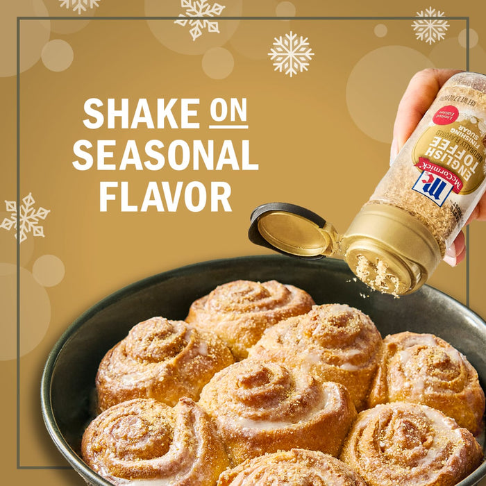 McCormick Cinnamon Sugar being sprinkled on a pan of freshly baked cinnamon rolls, emphasizing the addition of seasonal flavor.