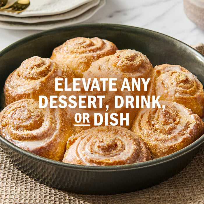 A pan of freshly baked cinnamon rolls with a glaze, suggesting they can elevate any dessert, drink, or dish.
