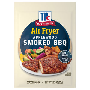 McCormick Air Fryer Applewood Smoked BBQ seasoning mix package with a serving suggestion of chicken and potatoes.