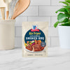 A packet of McCormick Air Fryer Smoked BBQ seasoning mix sits on a counter.