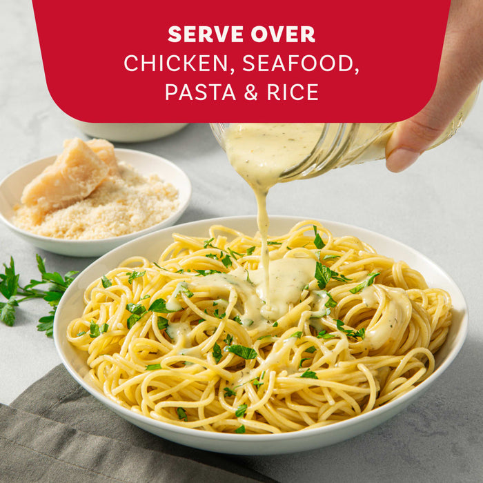 A delicious serving suggestion shows a creamy sauce made from the Mccormick Lemon Herb Butter All Purpose Sauce Mix Envelope .87 Oz being poured over a bowl of spaghetti garnished with fresh parsley.