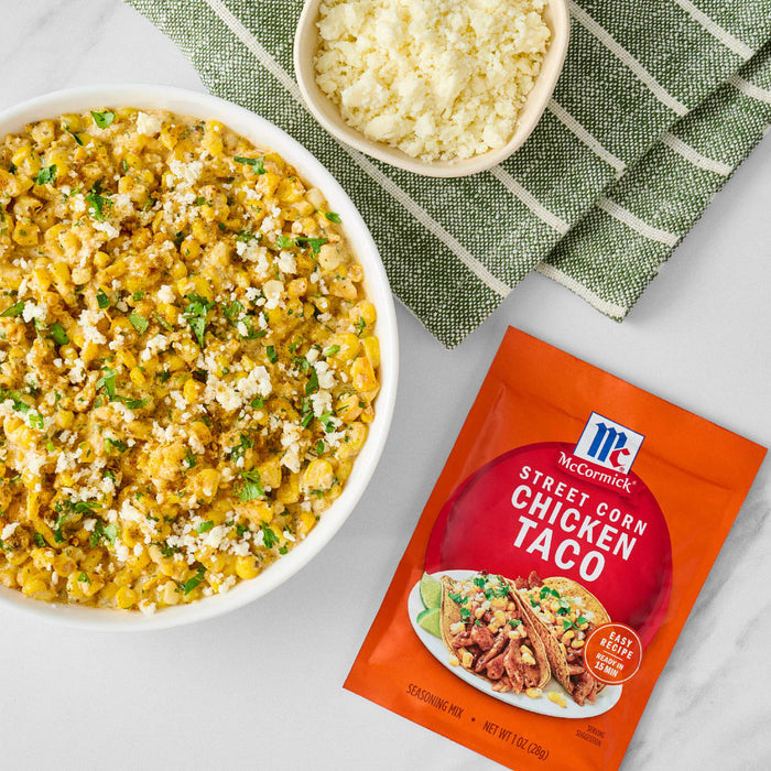 A bowl of taco rice with cheese and a packet of McCormick Street Style Chicken Taco seasoning.