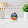 A packet of McCormick Perfect Pinch Crusted Chicken seasoning mix is displayed on a kitchen counter.