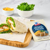 A delicious wrap made with McCormick Crunchy Chicken mix, lettuce, and cheese is displayed next to the product packaging.