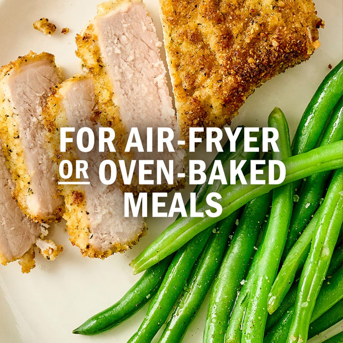 A plate of air-fried or oven-baked pork chops served with green beans.