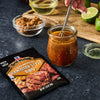 ['A packet of McCormick Grill Mates Hawaiian Style BBQ marinade mix is displayed next to a jar of marinade being whisked, with ingredients like brown sugar and lime nearby.']