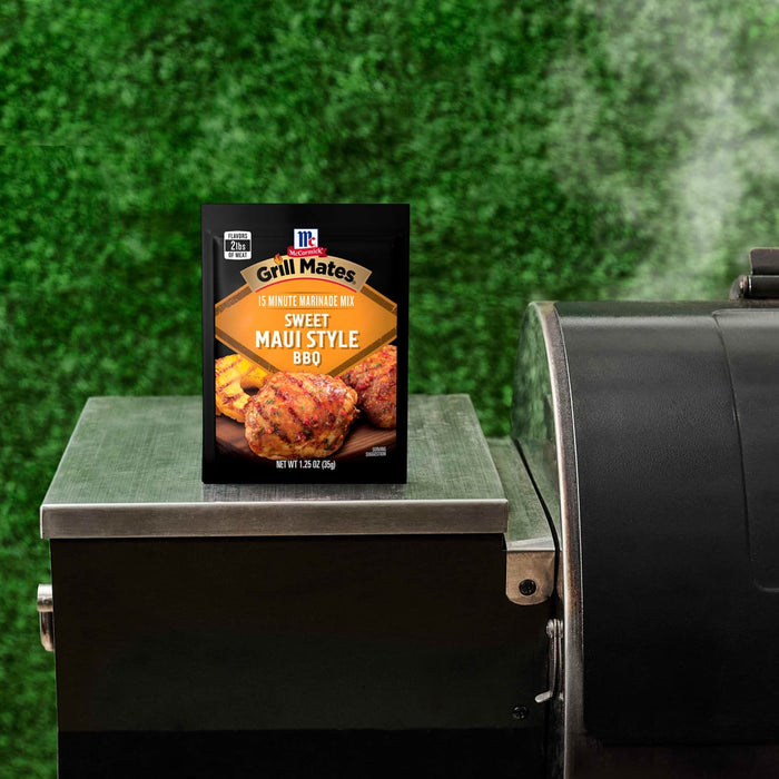 A packet of McCormick Grill Mates Hawaiian Style BBQ marinade mix sits on a grill.