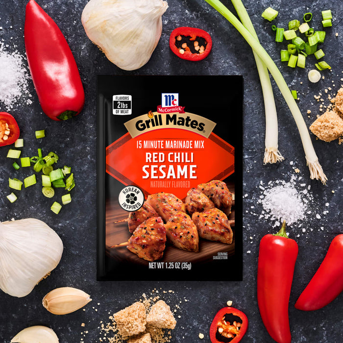 This is a product shot of McCormick Grill Mates Asian BBQ 15 Minute Marinade Mix surrounded by ingredients like garlic, peppers, and green onions.