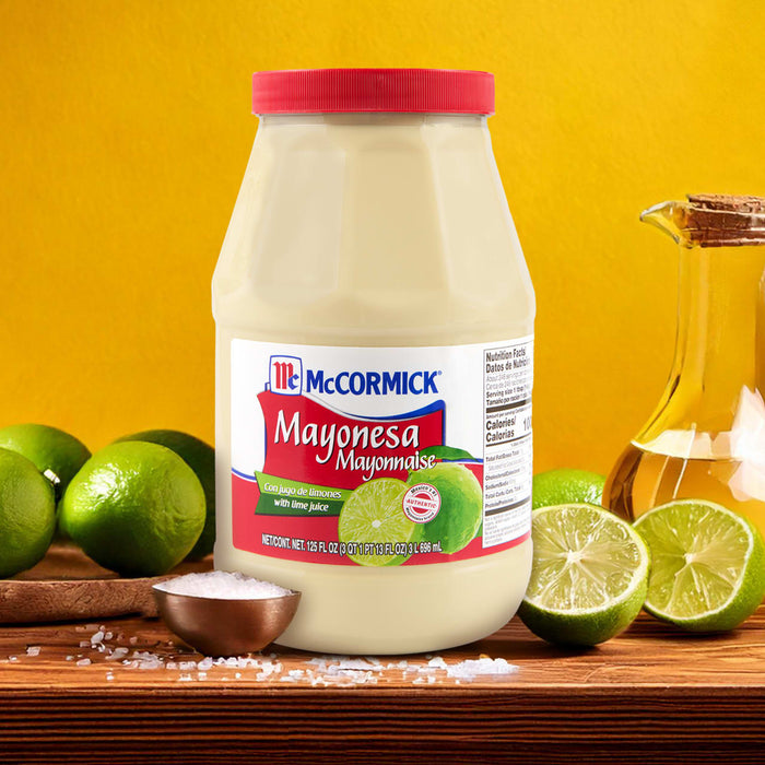 ['A jar of McCormick Mayonnaise with lime juice, next to limes and a bowl of salt.']