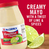 ['A jar of McCormick Mayonesa with lime juice, next to a lime wedge.']