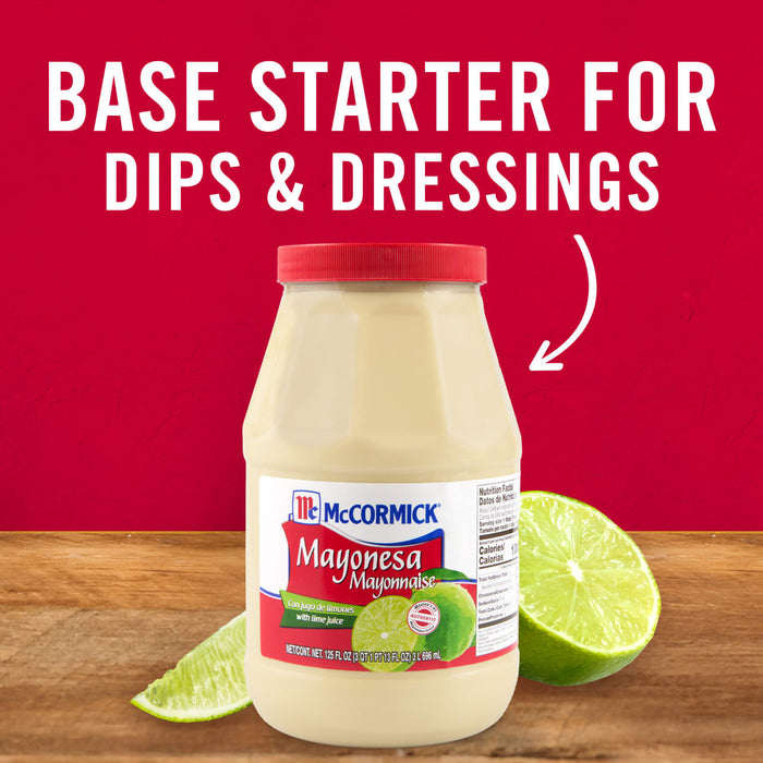 ['A jar of McCormick Mayonesa with lime slices on a wooden surface.']