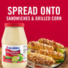 ['A jar of McCormick Mayonesa with grilled corn on the side.']