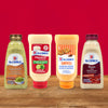 ['Four bottles of McCormick sauces: guacamole, mayonnaise, chipotle mayonnaise dressing, and bacon mayonnaise dressing.']