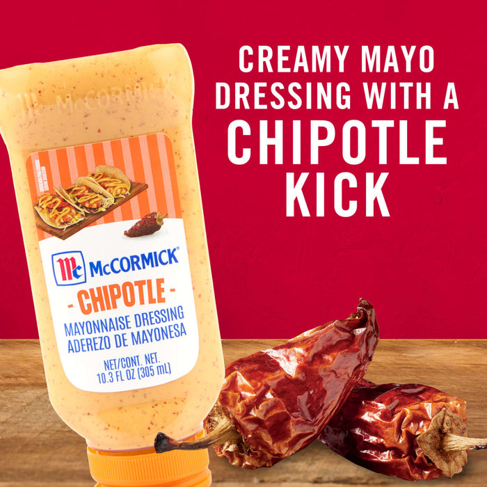 ['A bottle of McCormick Chipotle Mayonnaise Dressing with dried chili peppers.']
