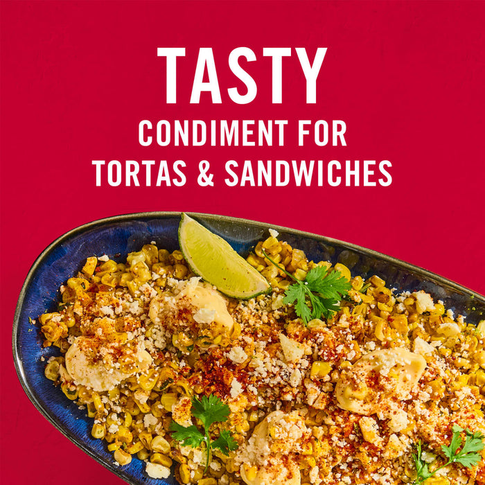 ['A bowl of corn salad with cotija cheese, lime, and cilantro, a tasty condiment for tortas and sandwiches.']