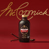 A bottle of McCormick vanilla extract is displayed against a red background with the McCormick logo.