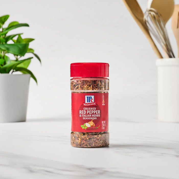 ['A bottle of McCormick Crushed Red Pepper &amp; Italian Herbs Seasoning.']
