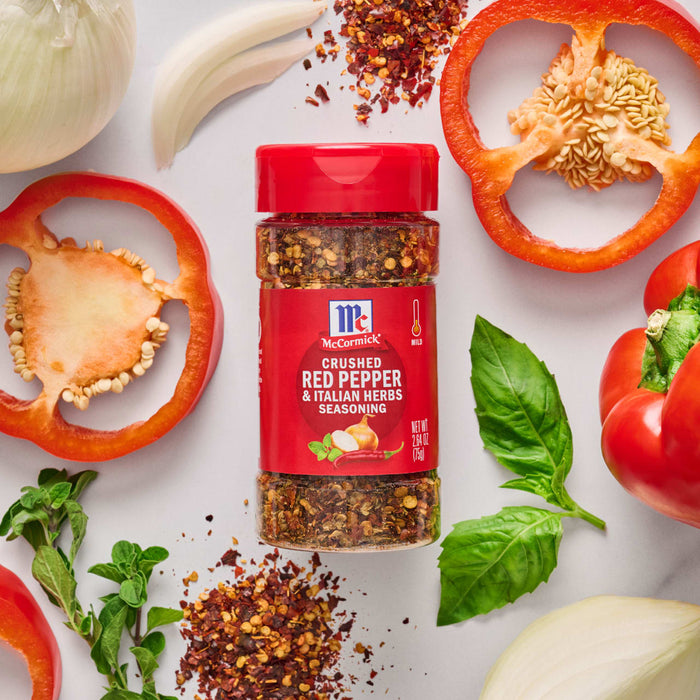 ['A jar of McCormick Crushed Red Pepper &amp; Italian Herbs Seasoning with red peppers, onions, and basil.']