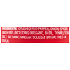 ['A red label with white text listing the ingredients for a crushed red pepper product.']
