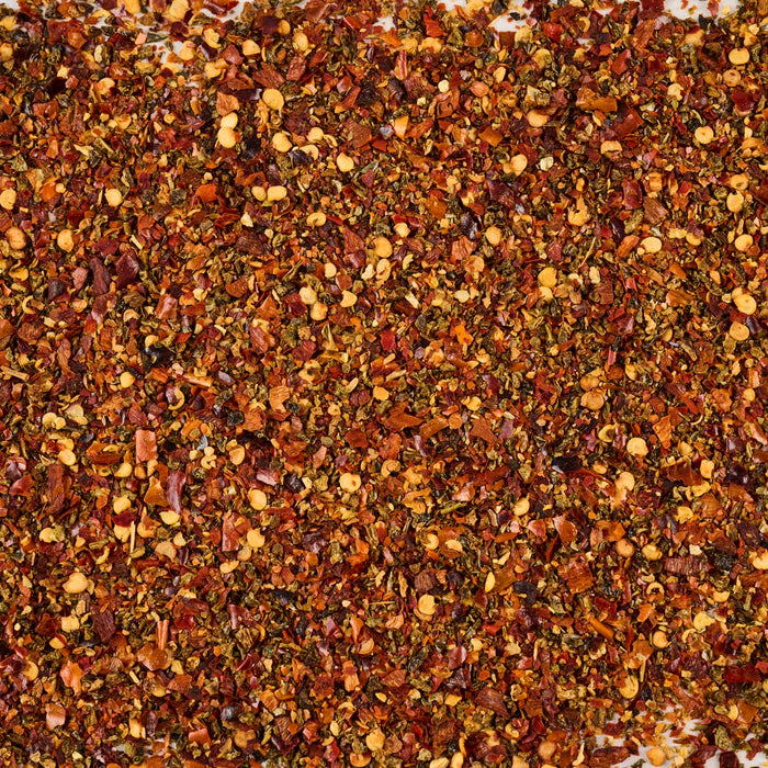 ['A close-up of a mixture of dried red pepper flakes and other spices.']