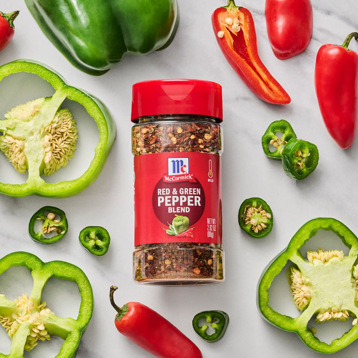 ['A jar of McCormick Red &amp; Green Pepper Blend surrounded by red and green peppers.']