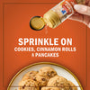 A hand sprinkles McCormick Maple Flavored Sugar and Spice Blend on cookies, cinnamon rolls, and pancakes.