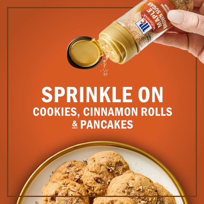 A hand sprinkles McCormick Maple Flavored Sugar and Spice Blend on cookies, cinnamon rolls, and pancakes.