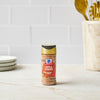 A bottle of McCormick Grill Mates Montreal Steak Seasoning sits on a kitchen counter.