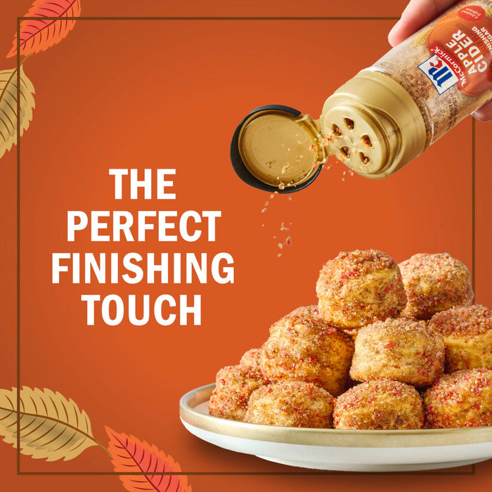A hand sprinkles McCormick cinnamon sugar blend onto a stack of golden-brown biscuits, highlighting it as the perfect finishing touch.