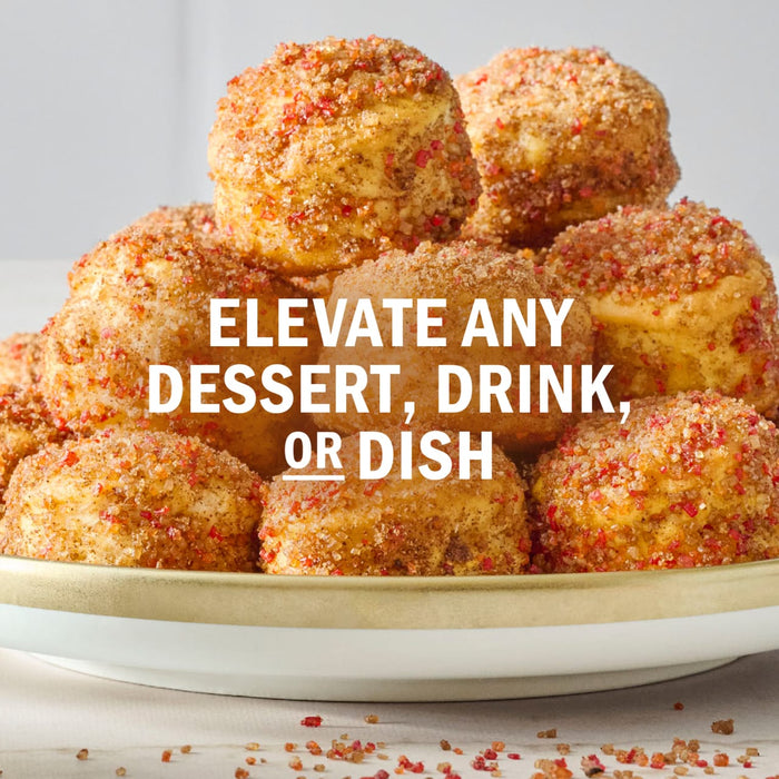 A stack of bite-sized desserts, possibly donut holes or muffins, are topped with a colorful sprinkle mix, suggesting they can elevate any dessert, drink, or dish.